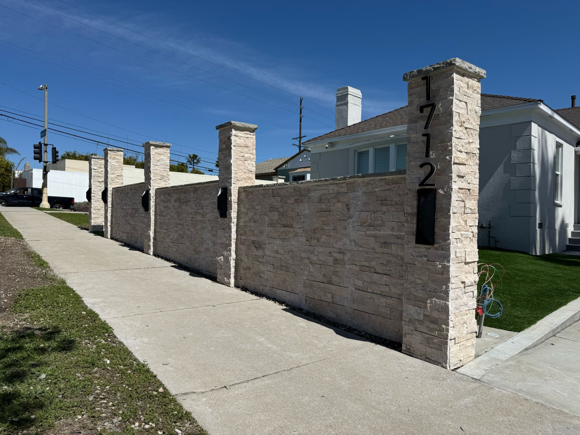 Newly installed black steel fence and gate on a Southern California residential street