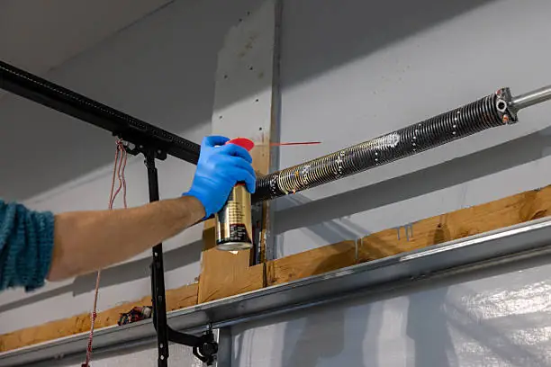 Lubrication of garage door hardware during maintenance
