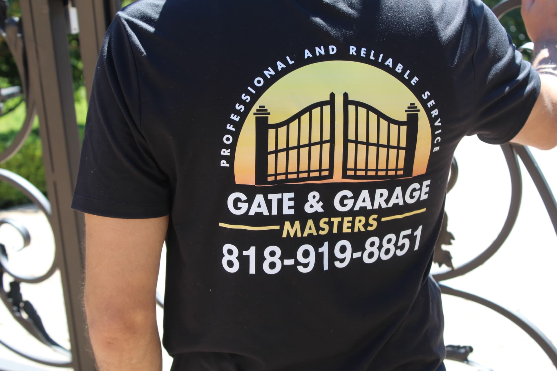 Uniformed technician with wrenches preparing for a gate maintenance visit