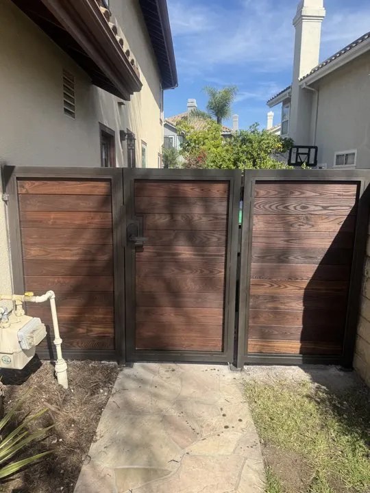 Wood-infill gate coordinated with adjoining garden panels