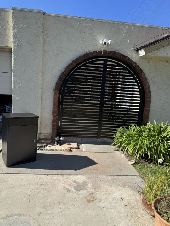Arched gate within the rounded masonry entrance