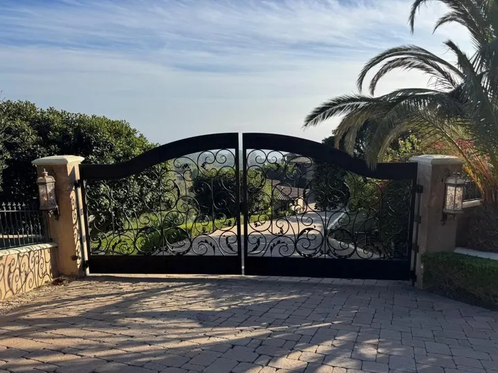 Decorative double gate closed across the driveway