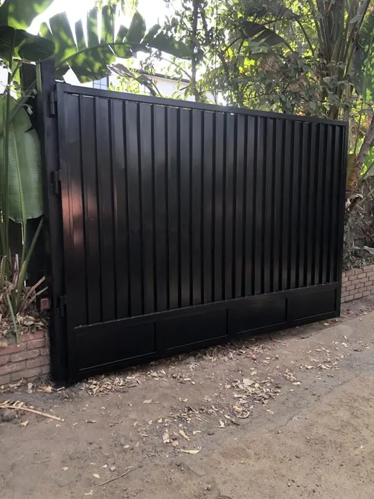Dark vertical panels along the garden boundary