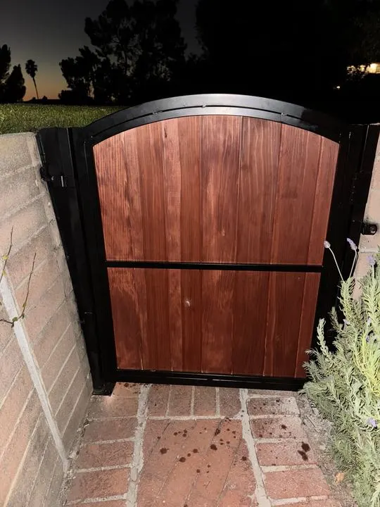 Arched timber entrance photographed after dark; separate project example.