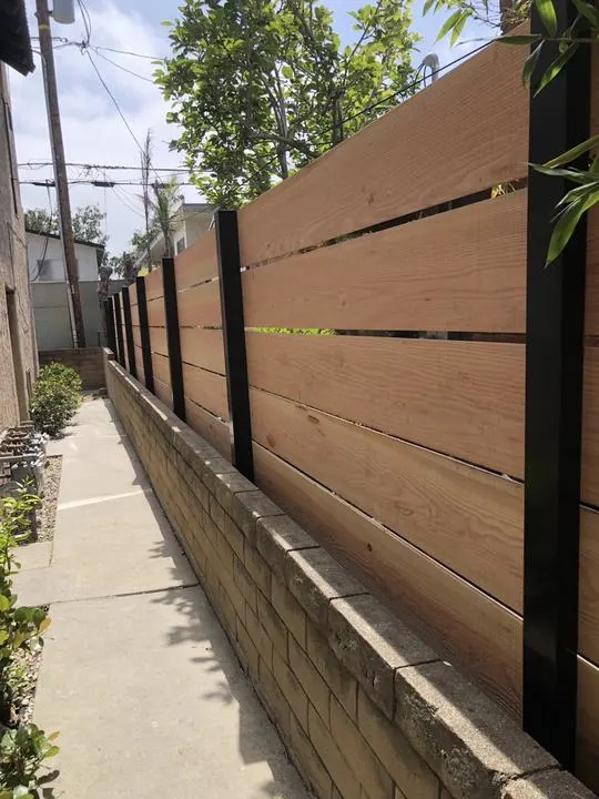 Horizontal wood boundary above a low wall