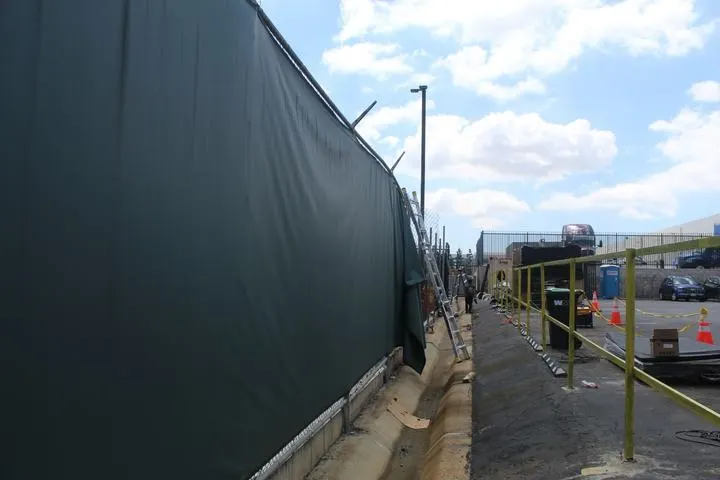 Screened commercial perimeter during site work.