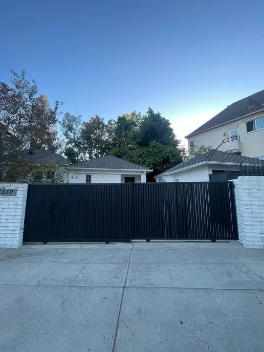 Closed vertical-slat driveway gate