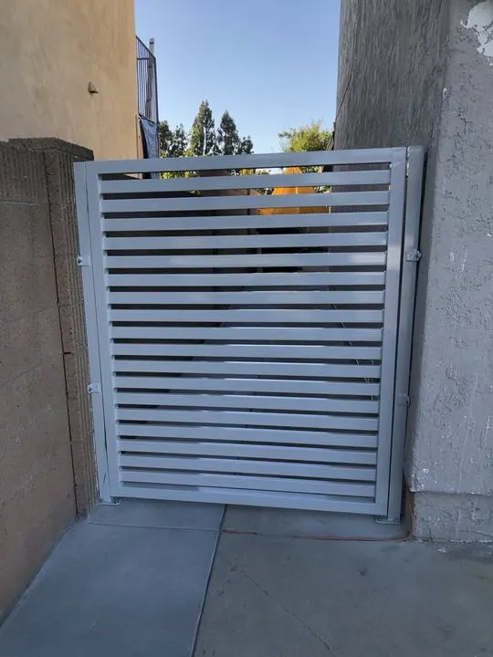White horizontal side-yard gate, closed.