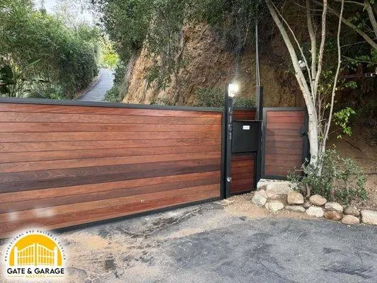 Horizontal wood-toned gate and adjacent entry section.