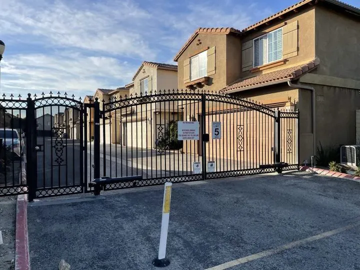 Decorative gate at a shared vehicle entrance.